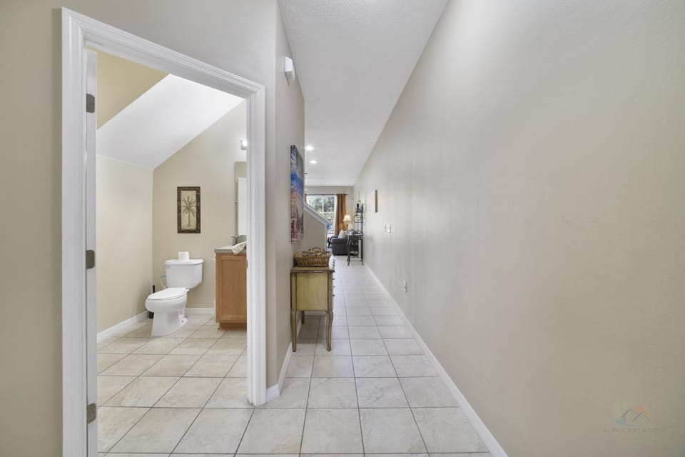 Bright hallway leading to a cozy living area with a convenient guest bathroom.