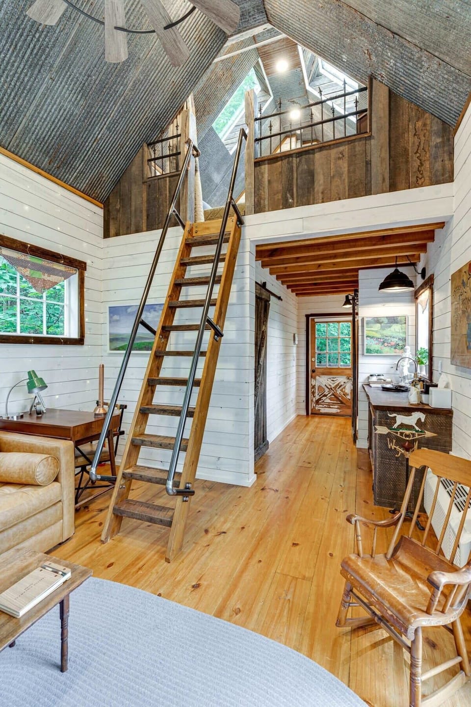 A view from the living space to the loft and front entrance
