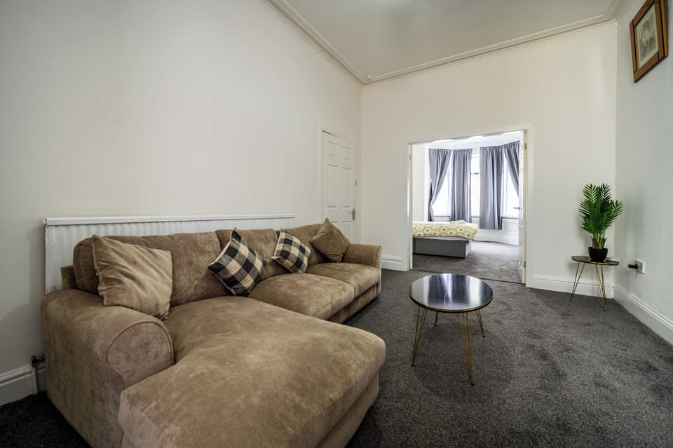 Bright and spacious living room with plenty of seating, central heating, double glazed window, sofa with table, tv etc. 