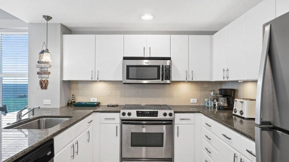 Your fully equipped kitchen features granite counters, stainless appliances, and everything needed for home cooking.
