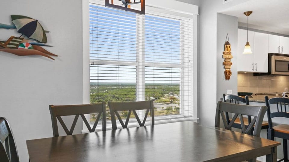 Gather around your dining table while savoring scenic views through expansive windows, creating the perfect backdrop for memorable meals together.