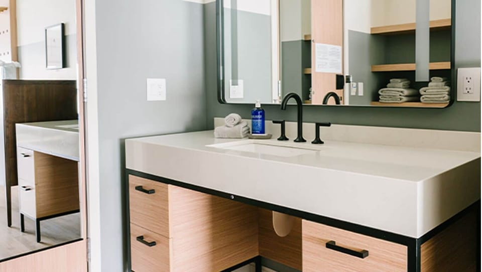 Refresh at the spacious vanity with modern matte-black fixtures.