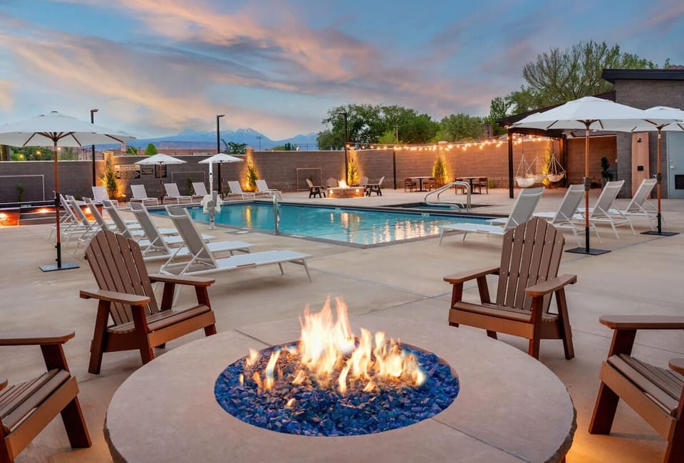 Gather by the glowing firepit and unwind poolside at dusk