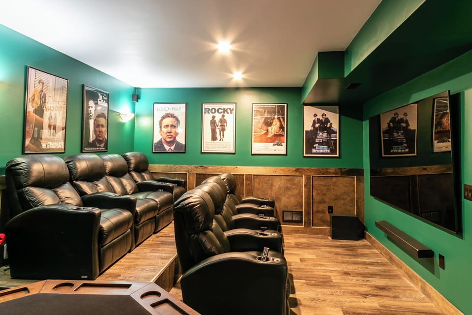 Movie theater with 8 power recliners and 98" QLED TV and premium sound system. 