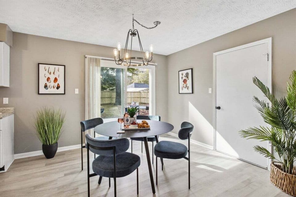Dine with a view—this bright and airy dining area features large doors that open to the backyard patio for the perfect indoor-outdoor vibe.