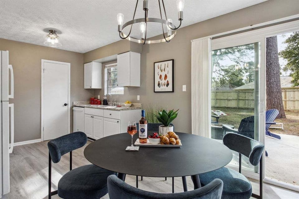 Gather around the dining table for home-cooked meals, game nights, or morning coffee in this welcoming and light-filled space.