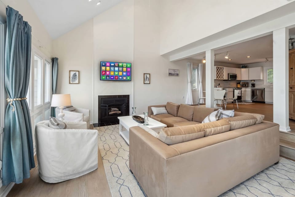Living Room: Bright space with plush seating, a sleek Smart TV, and a breezy coastal vibe!