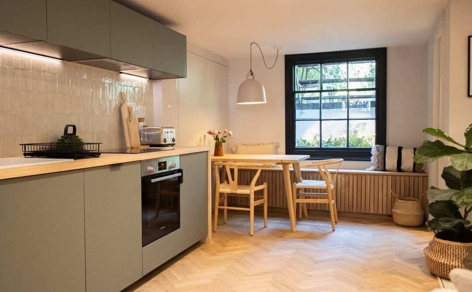 The kitchen seamlessly integrated with a spacious dining table, perfect for enjoying meals and gatherings with loved ones.