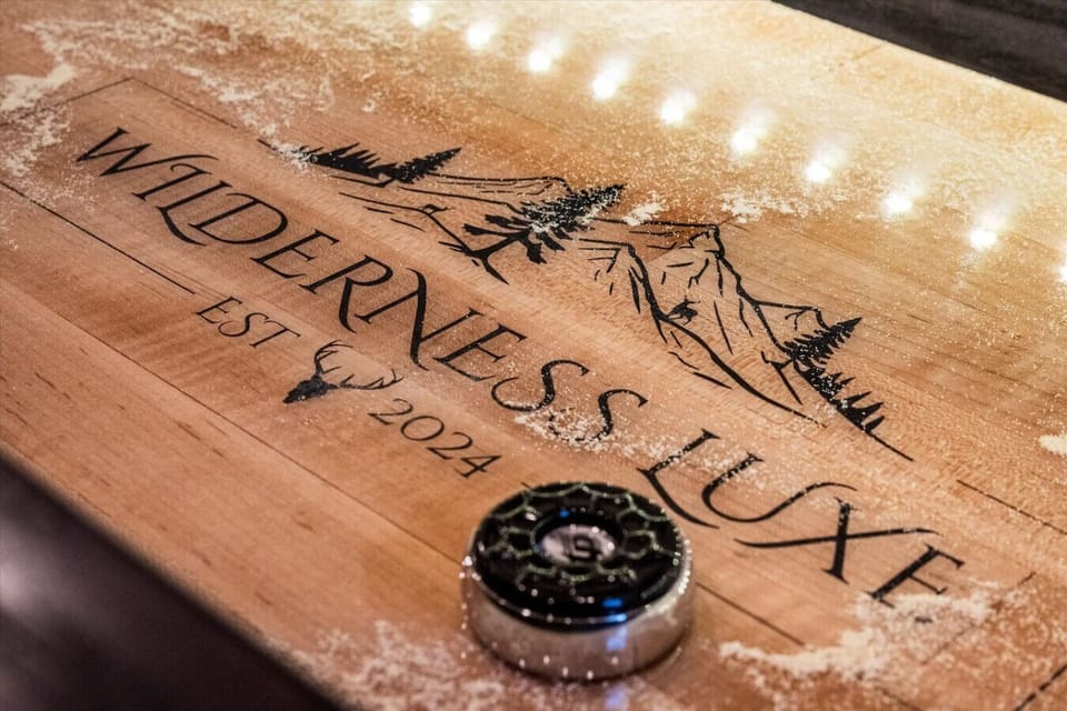 The living area includes a variety of entertainment options, including this custom-branded shuffleboard game.