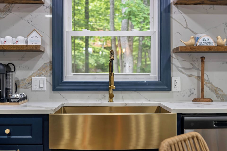 A stylish gold sink adds a touch of elegance and luxury to the kitchen space.