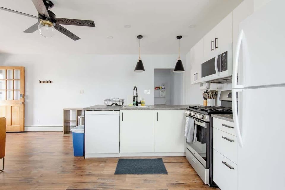 Brand new full kitchen featuring gas range, over the range microwave, dishwasher and pantry. 