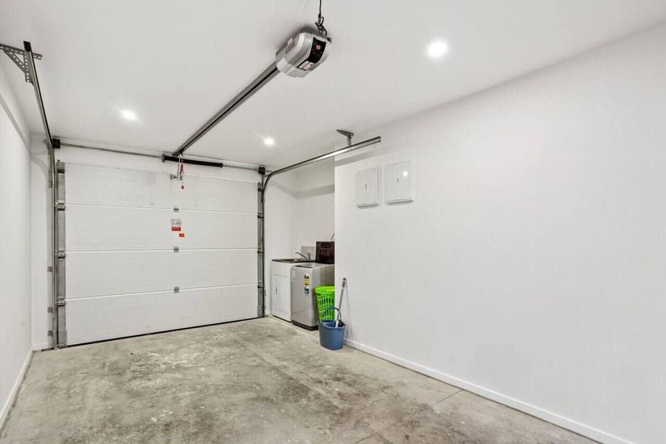The laundry has a top-loading washing machine and laundry tub.