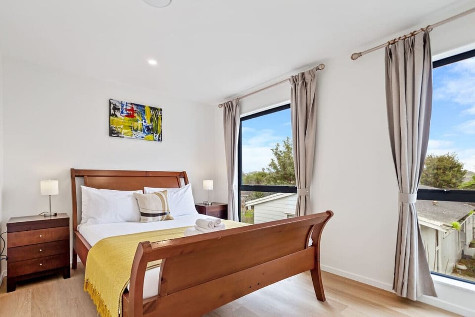The bedroom exudes calm and serenity, bathed in soft, natural light streaming through the window.