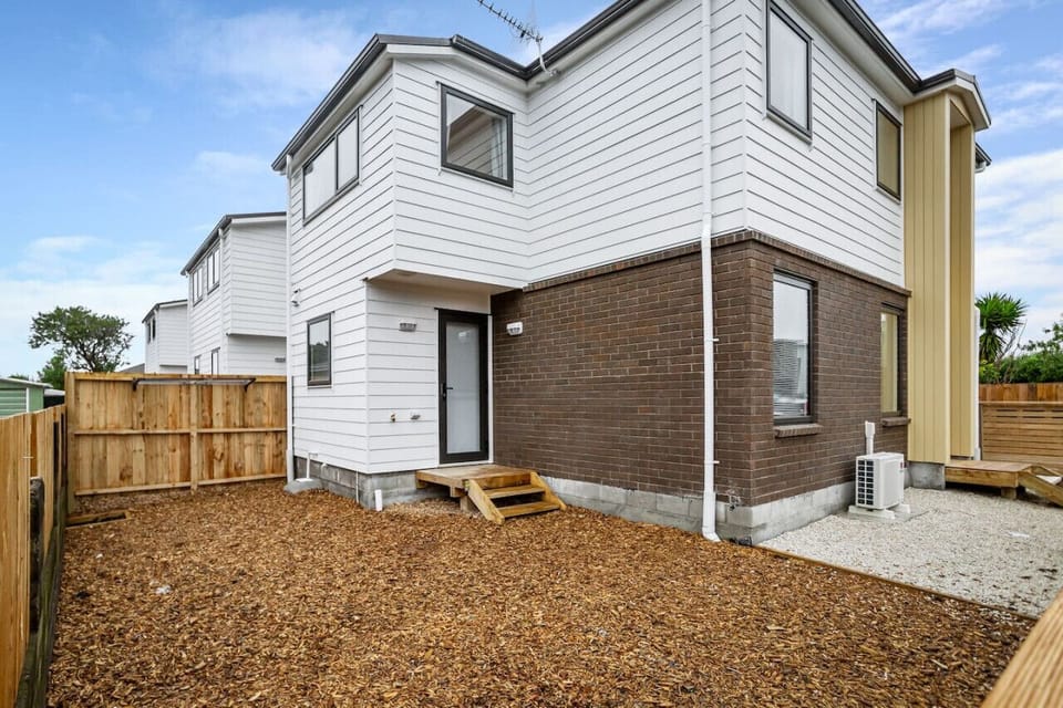 View of the townhouse that shows the backyard and clothes line.
