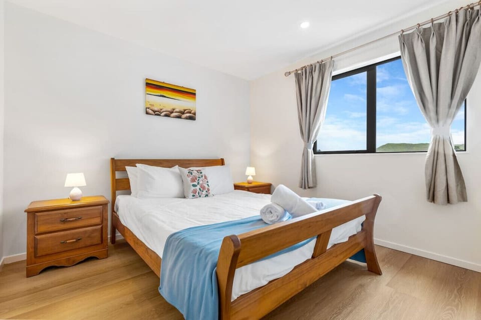 The Queen bed looks inviting with its crisp white sheets and comfy throw.