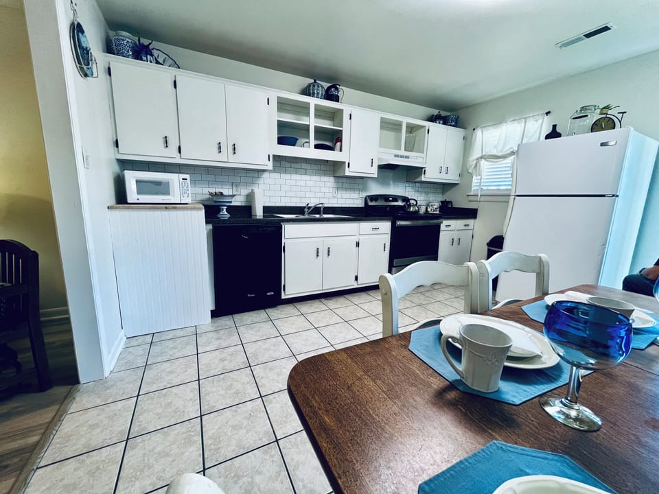 Fully set up kitchen utensils, pots and pans and supplies for basic meals.