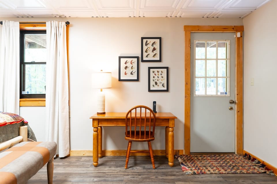 Workspace with a desk, chair, and natural light, perfect for remote work or planning your Hocking Hills adventure