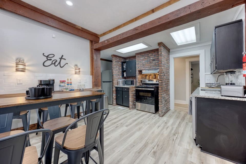 Enjoy a fully equipped kitchen with modern appliances, warm wood beams, and charming brick accents. The large dining table seats up to 12, making it perfect for shared meals, morning coffee, and gathering with family and friends.
