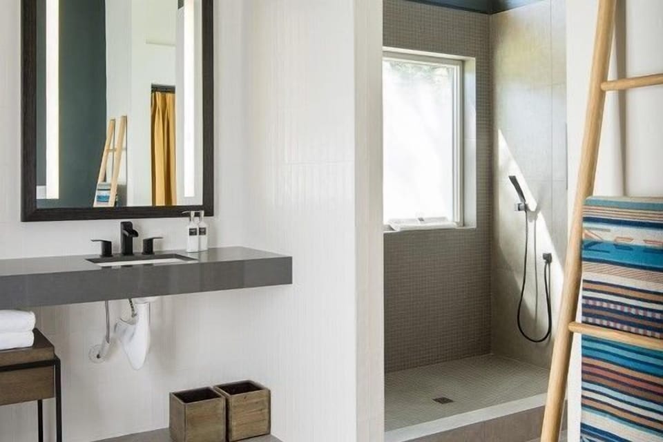 Refresh in a sleek, modern bathroom featuring elegant fixtures and abundant natural light.