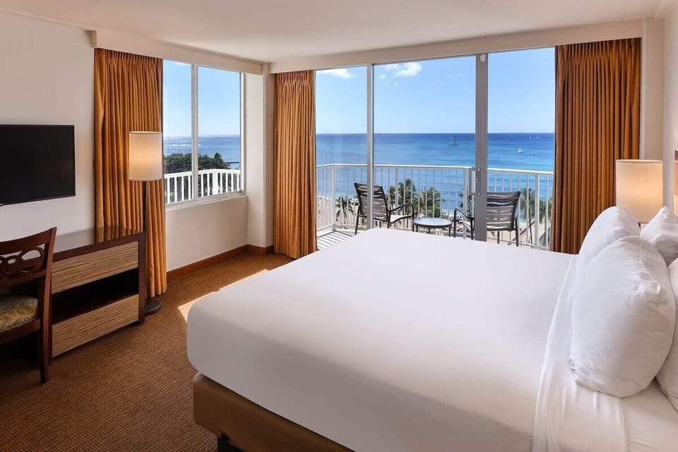 Step into your airy oceanview bedroom and instantly relax.