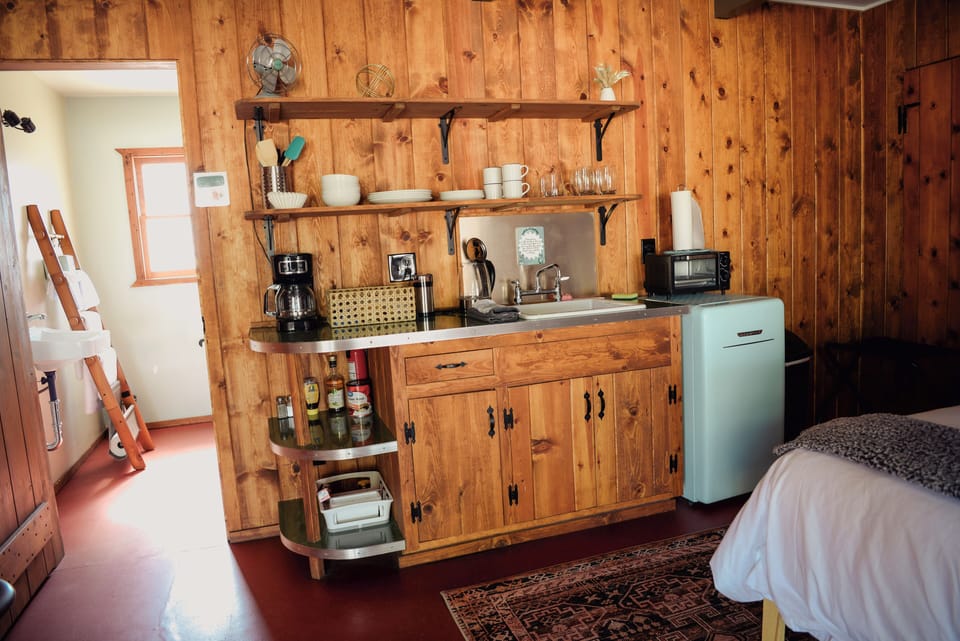 Room includes fully stocked kitchenette with mini fridge and JT Coffee co coffee.