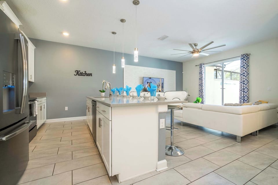 Pull up to the island bar with premium stainless stools overlooking the living space – a sleek hub for morning coffee, evening cocktails, and casual conversation.