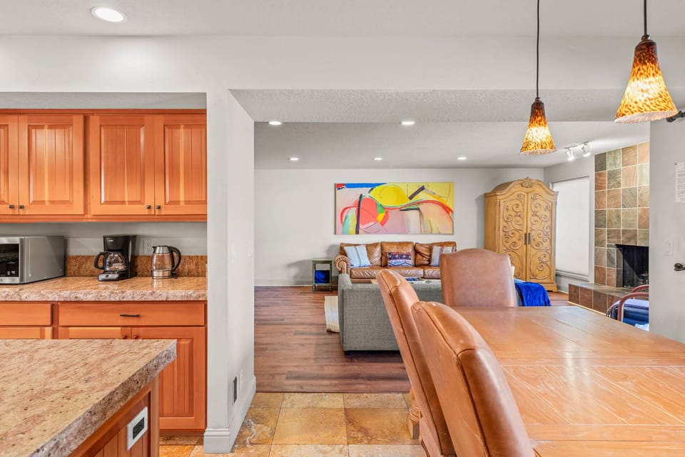 Step into your inviting open-concept retreat where warm wood tones and thoughtful lighting create a welcoming flow from the fully equipped kitchen through the comfortable living spaces—perfect for relaxing after a day of adventure.