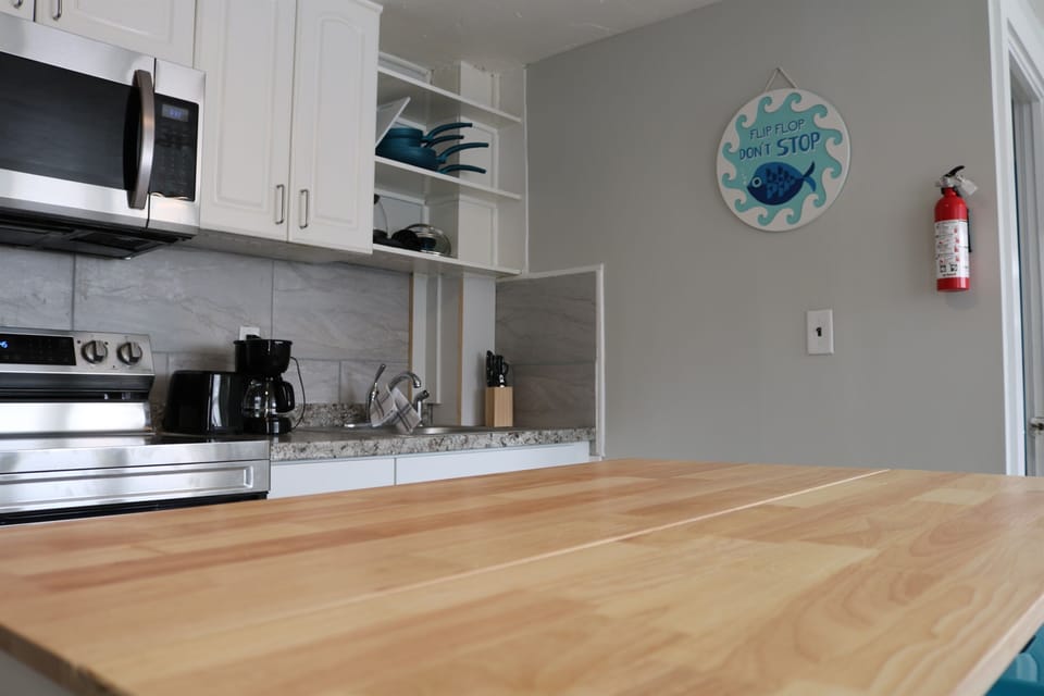 a fully stocked kitchen awaits complete with an island with seating for 2 and all the essentials.