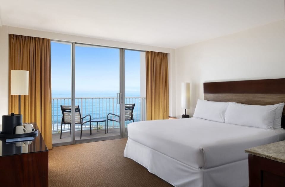 Unwind in crisp linens with sliding doors to the sea.