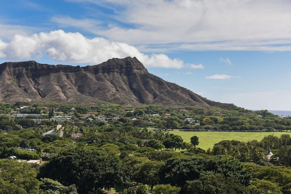 Explore lush island scenery and dramatic mountain backdrops nearby.