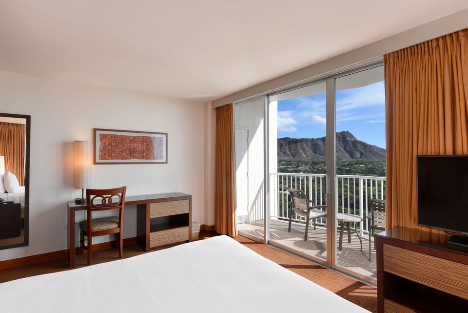 Unwind in a bright room with desk and balcony views.