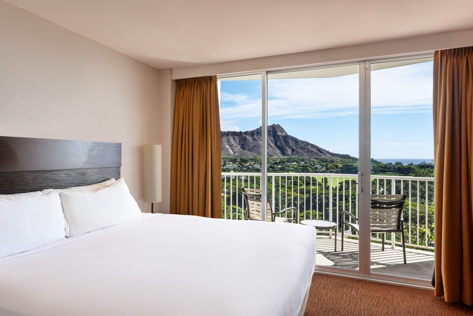 Stretch out in crisp linens while iconic mountains fill the window.