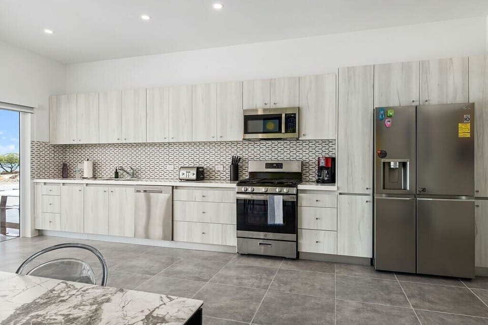 Kitchen
Fuel your stay with warmth and flavor in our welcoming kitchen. It's more than just a room; it's the heart of our home.