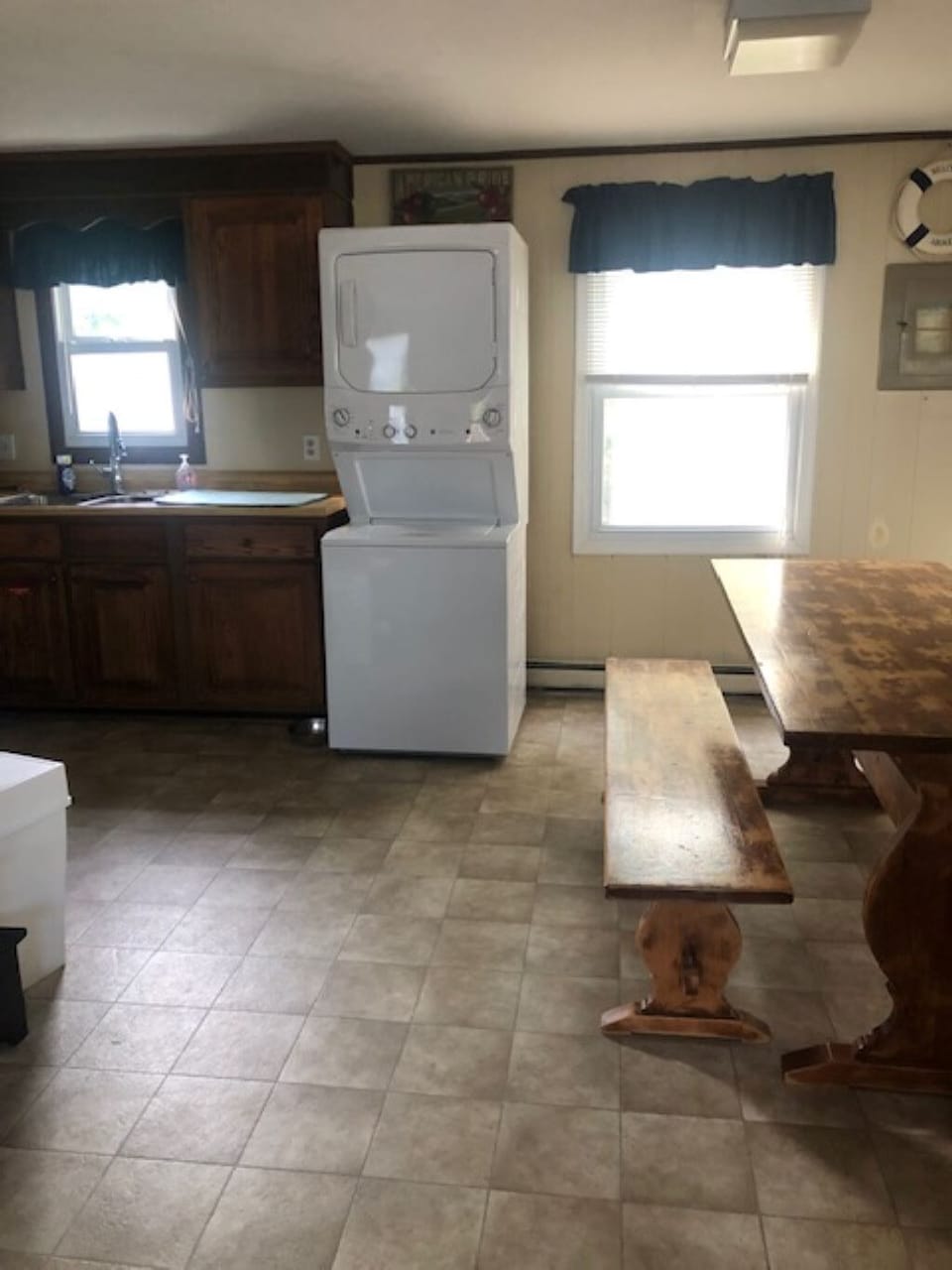 Stacked washer and dryer in the kitchen area.