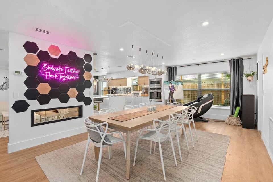 Open-concept living and dining with Bird House Forever Together neon sign, unique Winter Park rental