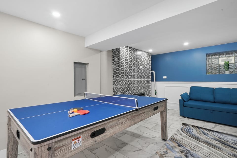 Basement Game Area with 75 Inch Samsung 4K TVs, Games, Sleeper Sofas, Fireplace