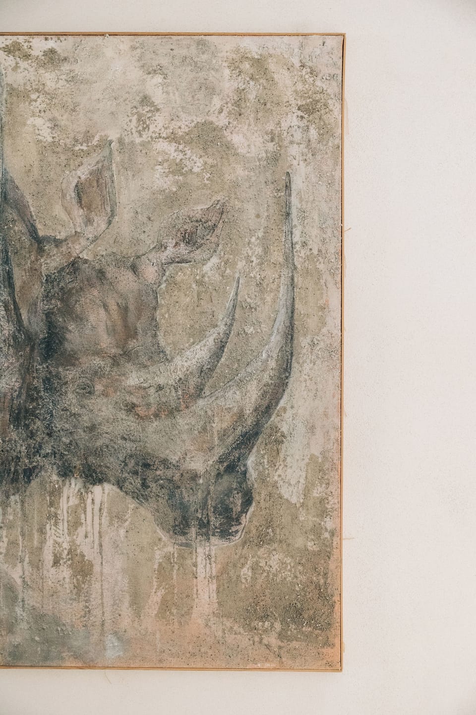 Lifestyle frame featuring a bold rhinoceros painting as a striking decor element