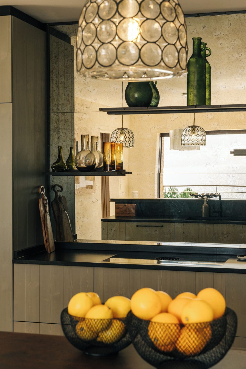 Aged mirror reflecting the serene sea view creating a timeless atmosphere.