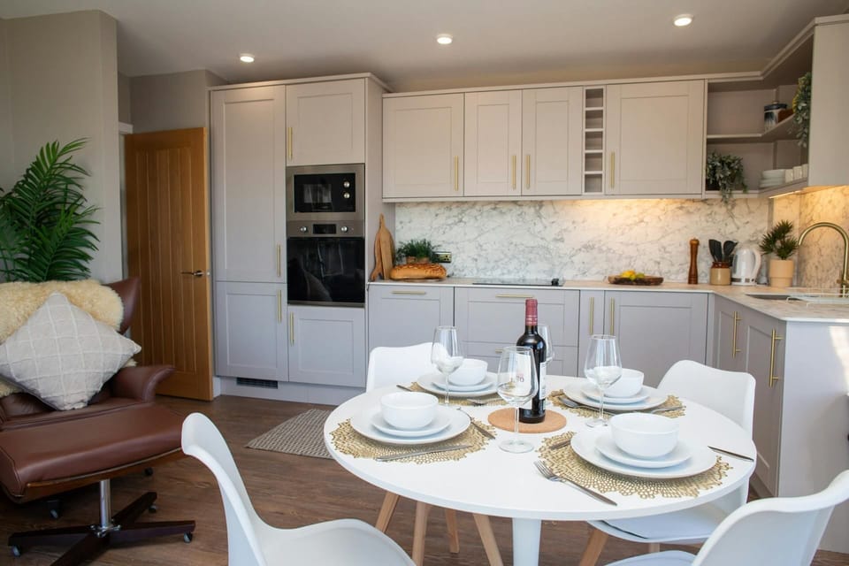 Dining table and four chairs laid for dinner