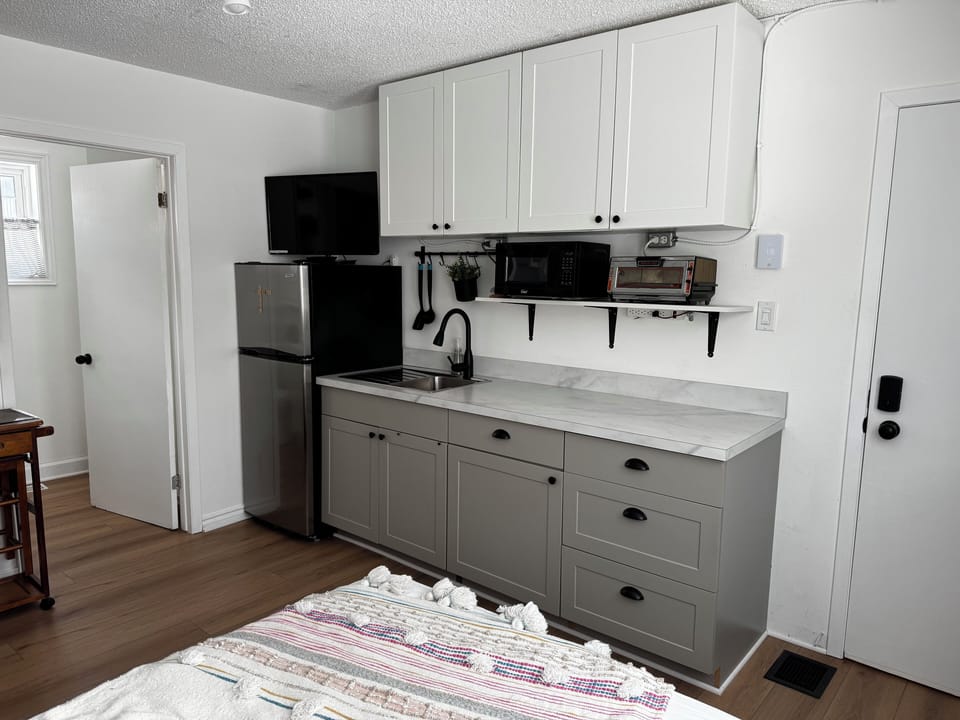 Fridge, induction cooktop, microwave, toaster, kettle, coffee, tea, utensils..