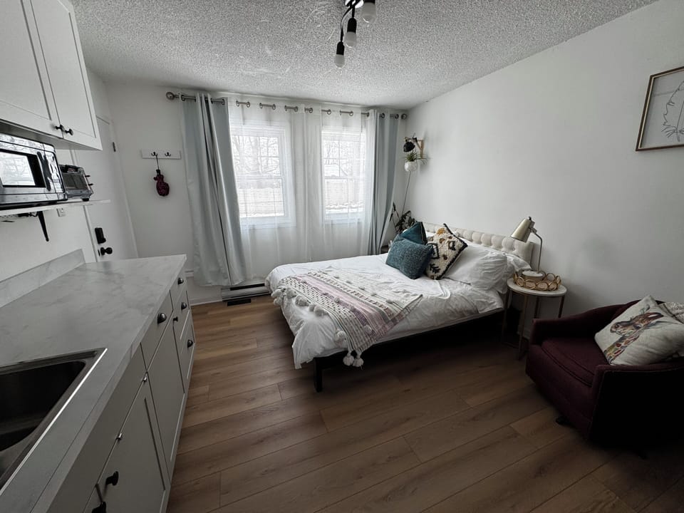 Queen bed, dining area, kitchenette with fridge, cooktop, microwave, toaster.