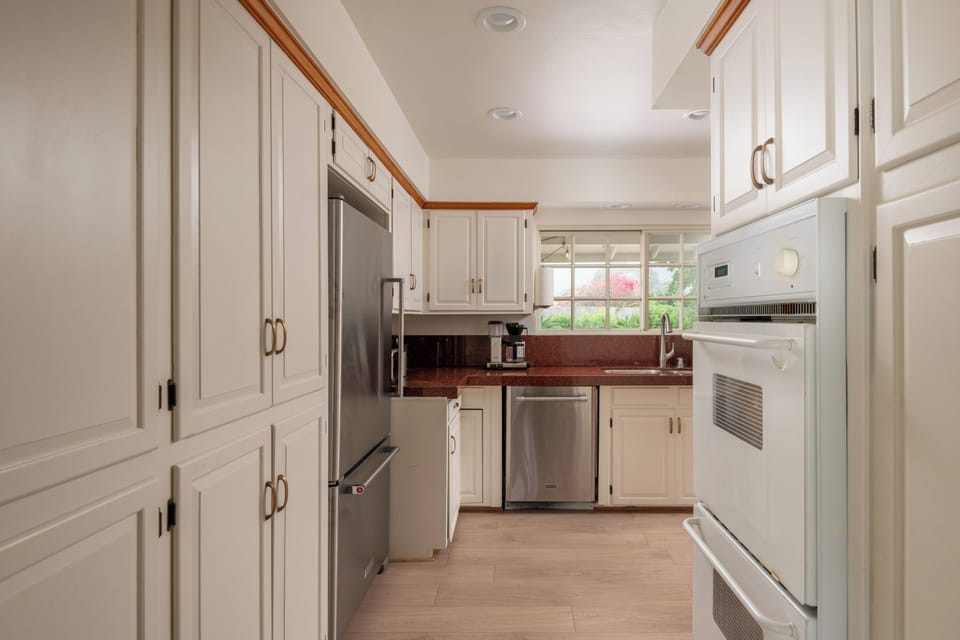 Full kitchen with oven stove, fridge and dishwasher. 