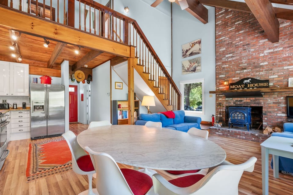 Fireplace brick surround that travels to meet the cathedral ceilings and adds a dramatic flair to the space