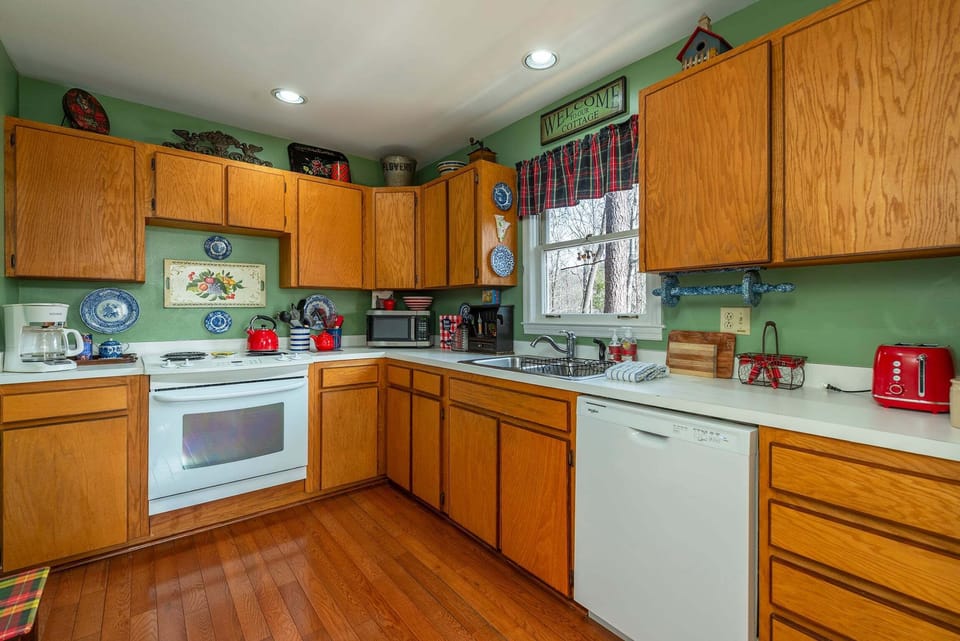 Kitchen with dishwasher, Dutch oven, blender, food processor & standard drip coffeemaker.