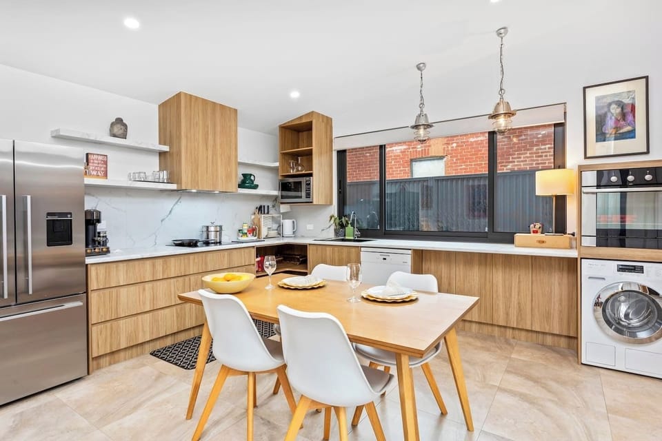 A full kitchen equipped with premium European appliances overlooks your private courtyard.