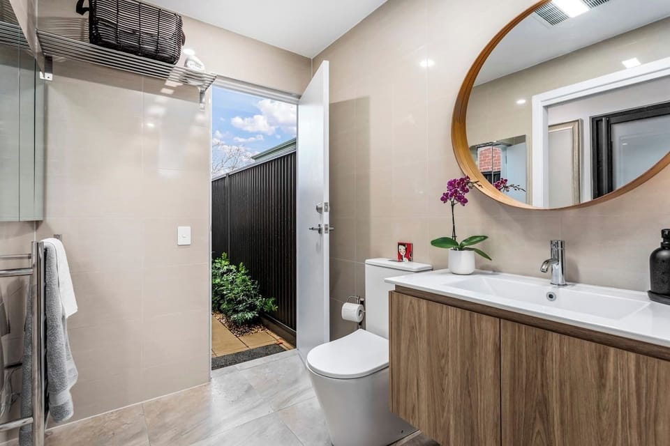 A spacious separate bathroom featuring heated towel rails, a generous shower, ample storage for longer stay and a powerful overhead heater for cosy winter mornings - plus direct access to your private courtyard.