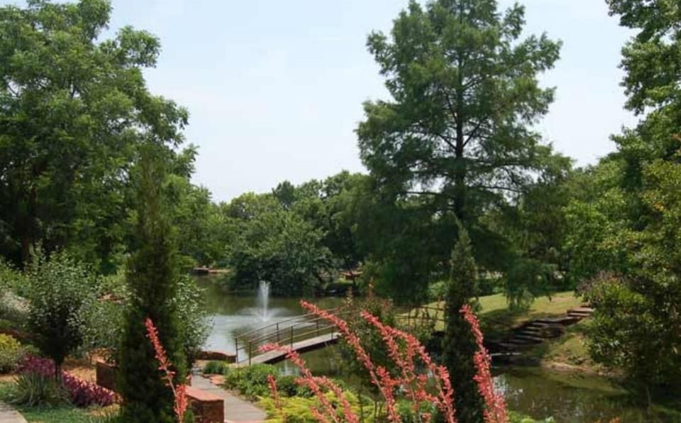  A tranquil park offering walking trails, colorful gardens, and a serene pond, perfect for a leisurely day outdoors.
