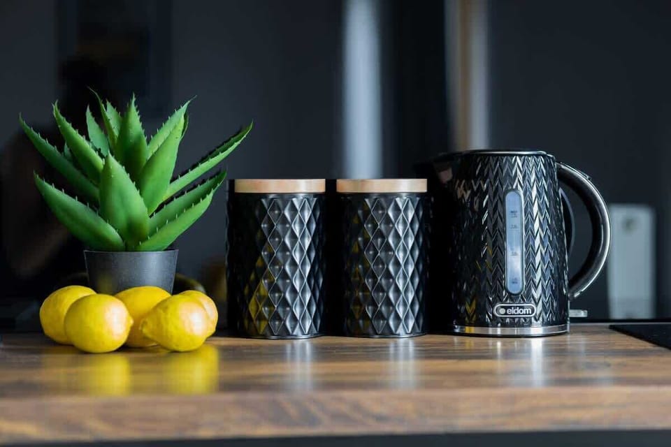 A kitchen counter detail with lemons and ceramic mugs highlights the cosy feel of the space.