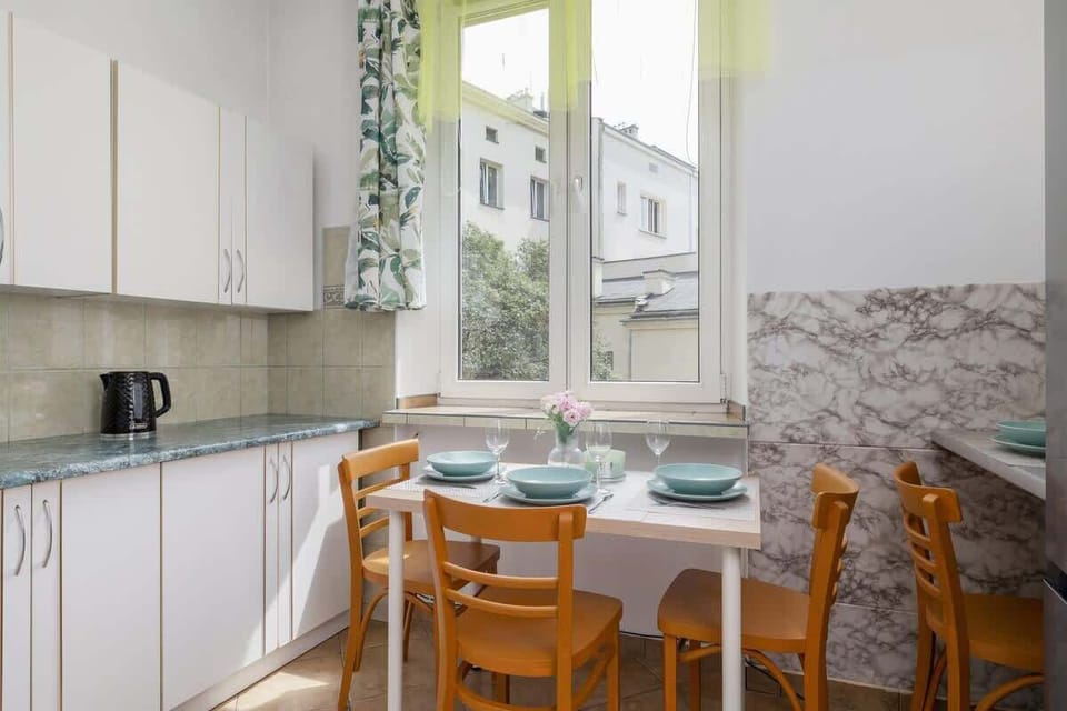 A dining area by a large window lets you enjoy meals in natural light.