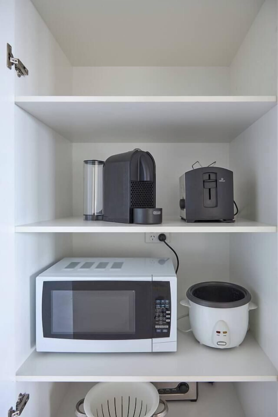 This kitchen comes equipped with a coffee machine, toaster, microwave, and rice cooker for easy, everyday convenience.